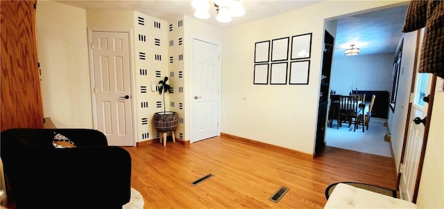 sitting room featuring hardwood / wood-style floors and a chandelier