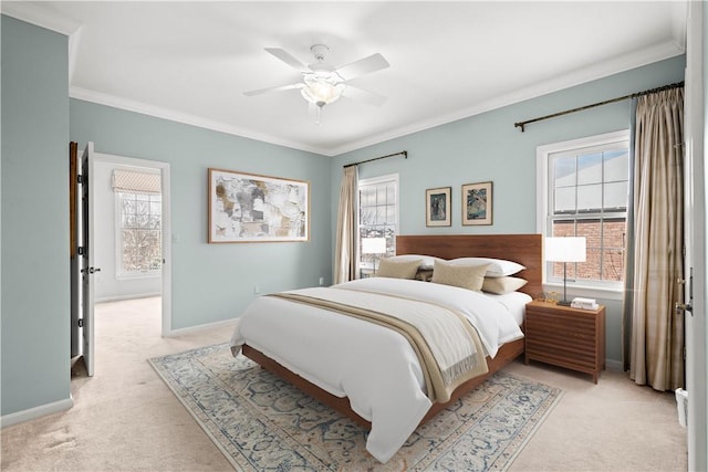 carpeted bedroom featuring ceiling fan and crown molding