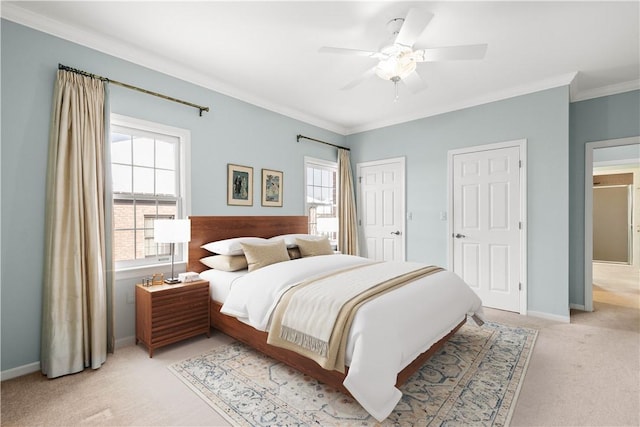 bedroom with light carpet, ceiling fan, and crown molding