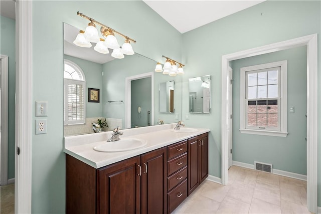 bathroom featuring vanity, tile patterned floors, and backsplash