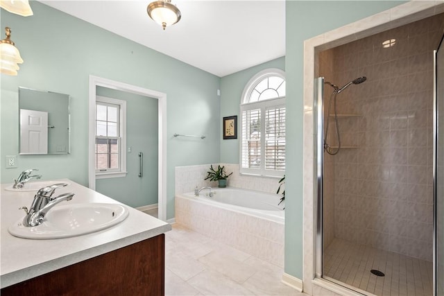 bathroom featuring tile patterned floors, vanity, and plus walk in shower