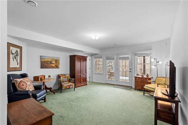 living area featuring light colored carpet