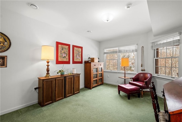 sitting room featuring light carpet