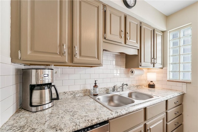 kitchen featuring light brown cabinetry, backsplash, a healthy amount of sunlight, and sink