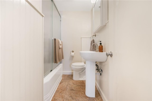 bathroom featuring shower / bath combination with glass door and toilet