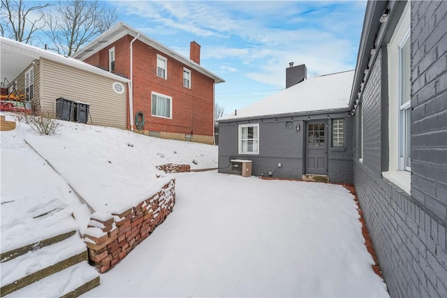 snowy yard featuring central AC unit