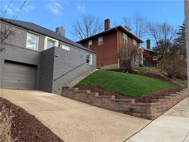 view of property exterior with a garage and a lawn