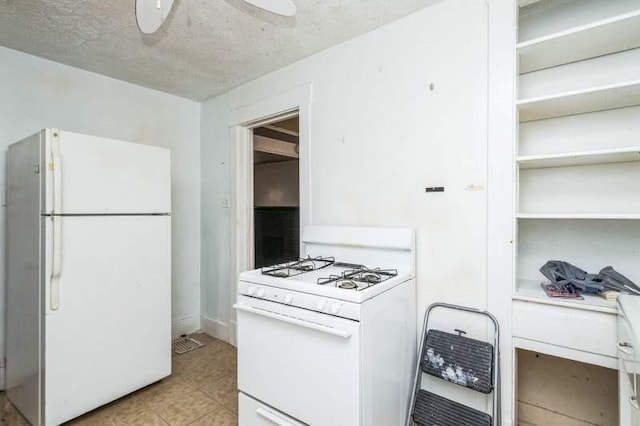 kitchen with white cabinets, ceiling fan, white appliances, and a textured ceiling