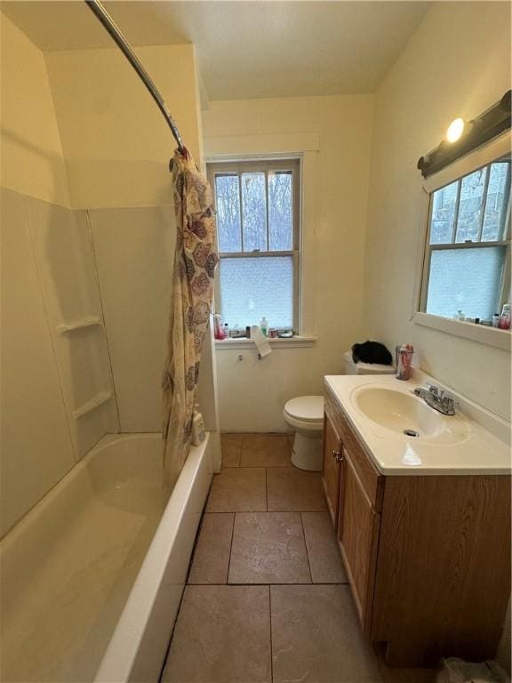 full bathroom featuring tile patterned flooring, vanity, toilet, and shower / tub combo with curtain