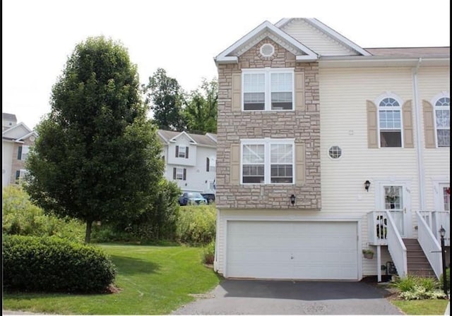 view of front of property with a garage and a front yard