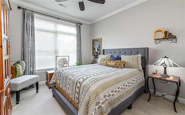 carpeted bedroom featuring ceiling fan and ornamental molding