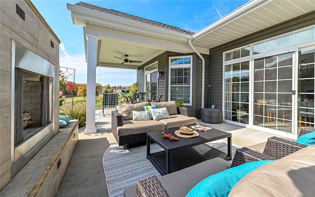 view of patio with an outdoor living space and ceiling fan