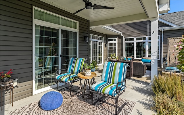 view of patio with an outdoor living space and ceiling fan