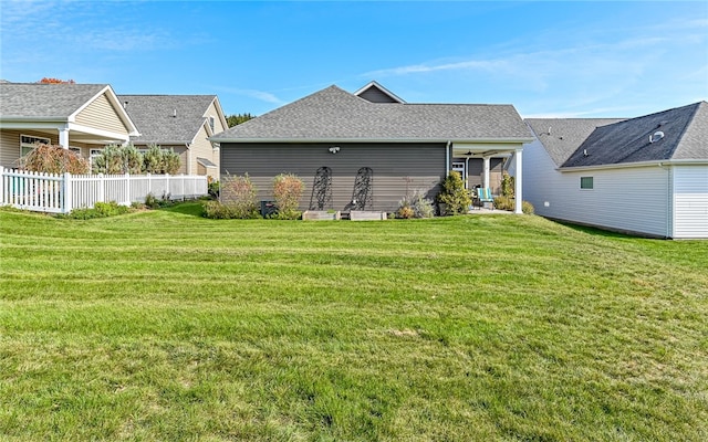 rear view of house with a lawn