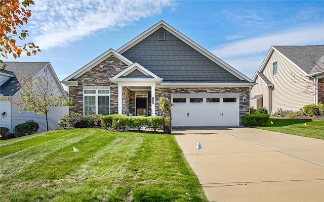 view of front of property featuring a front yard and a garage