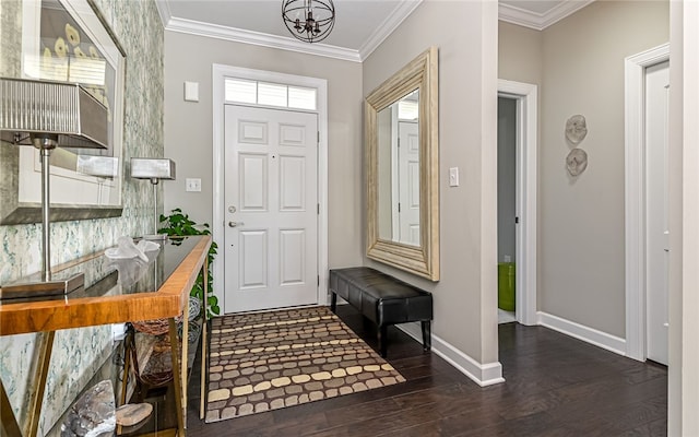 foyer entrance with a notable chandelier, dark hardwood / wood-style floors, and crown molding