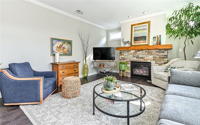 living room with hardwood / wood-style floors, a stone fireplace, and crown molding