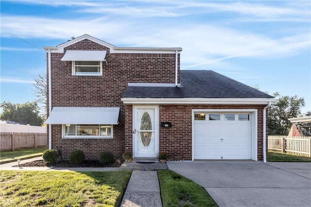 view of front facade with a front yard and a garage