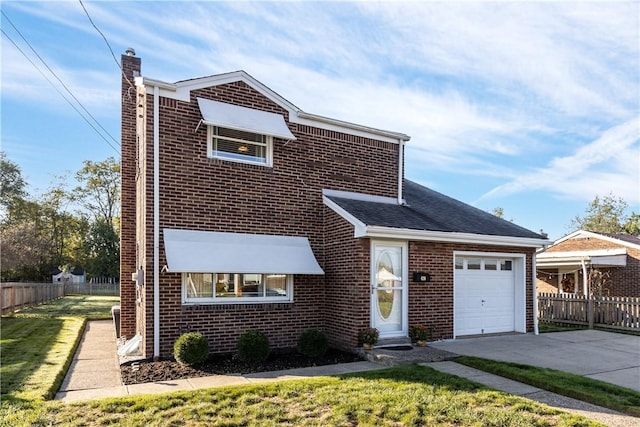 view of front of property featuring a garage and a front lawn