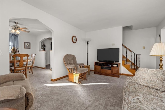 carpeted living room with ceiling fan