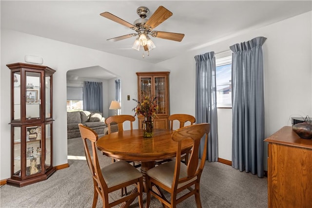 carpeted dining room featuring ceiling fan