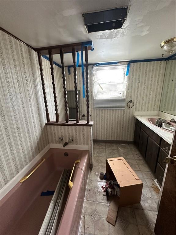 bathroom with vanity and a bath