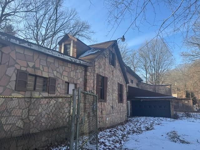 snow covered property featuring a garage