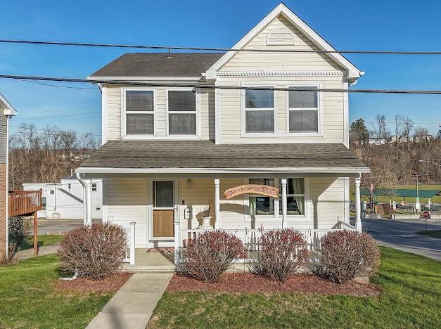 view of front of house featuring a front lawn and covered porch