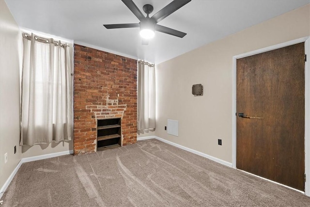 unfurnished living room featuring plenty of natural light, carpet, and a brick fireplace