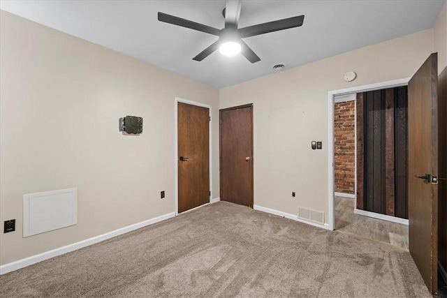 unfurnished bedroom featuring ceiling fan and light colored carpet