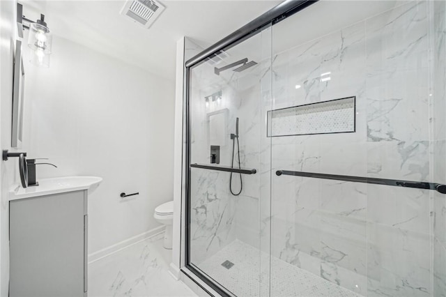 bathroom with vanity, toilet, and a shower with door