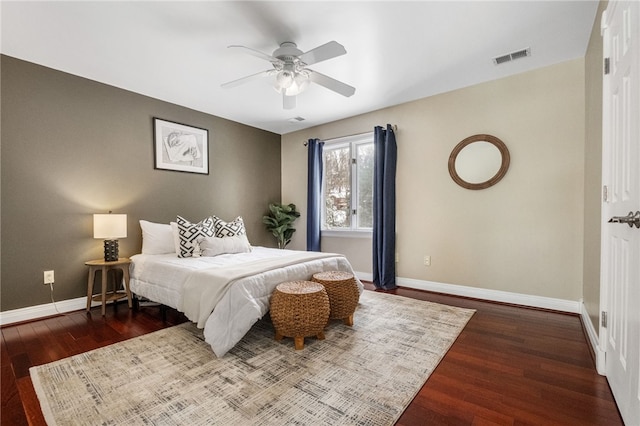 bedroom with ceiling fan and dark wood-type flooring