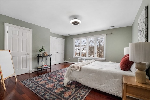 bedroom featuring dark wood-type flooring and a closet