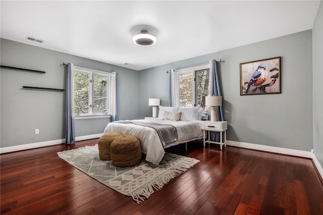 bedroom with dark wood-type flooring