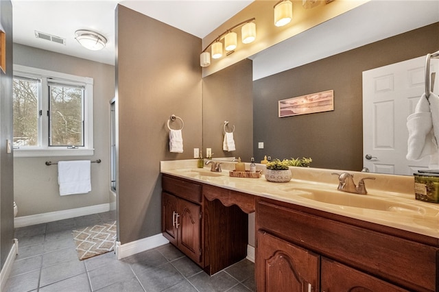 bathroom featuring tile patterned floors, vanity, and enclosed tub / shower combo