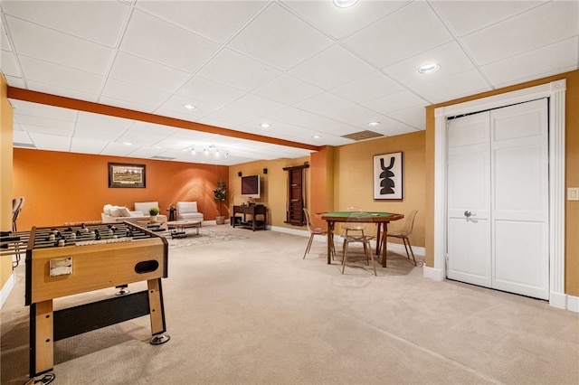 game room featuring a drop ceiling and carpet floors