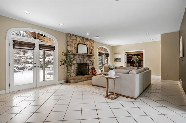 tiled living room featuring a fireplace and french doors