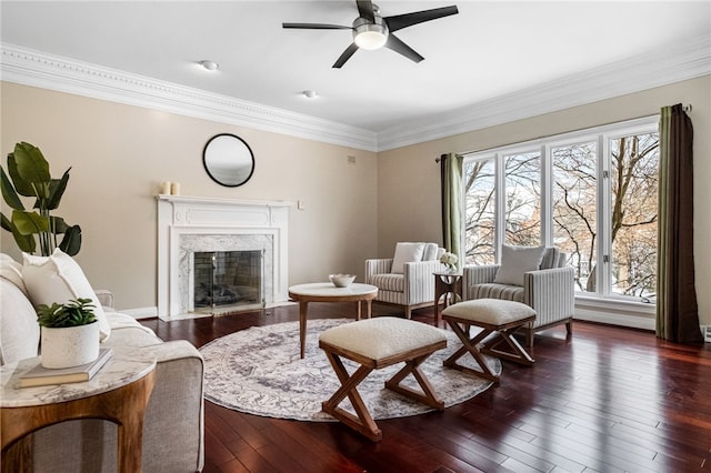 living room with a wealth of natural light, ceiling fan, a premium fireplace, and dark hardwood / wood-style floors