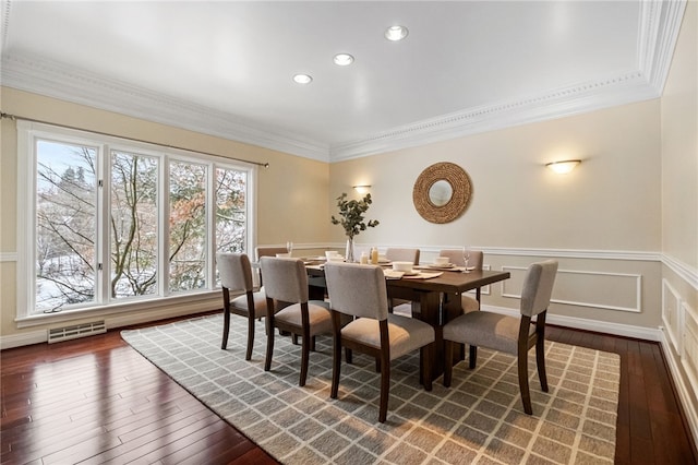 dining area with dark hardwood / wood-style flooring and crown molding