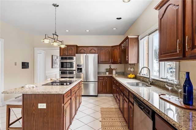 kitchen featuring sink, stainless steel appliances, light tile patterned floors, decorative light fixtures, and a kitchen island