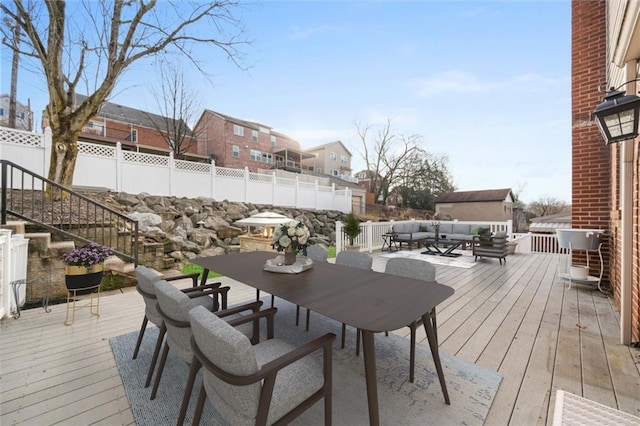 wooden terrace with an outdoor hangout area