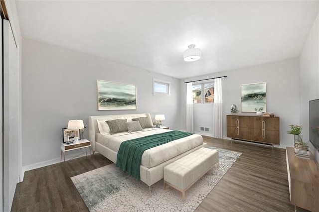 bedroom with dark hardwood / wood-style flooring