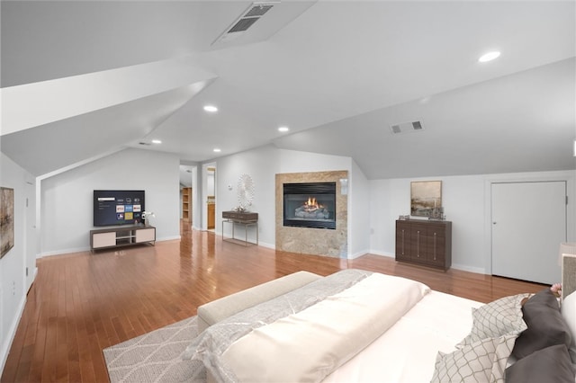 bedroom with hardwood / wood-style floors and vaulted ceiling