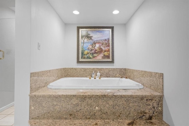 bathroom with tile patterned floors and a relaxing tiled tub