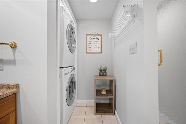 laundry room with stacked washing maching and dryer and light tile patterned floors