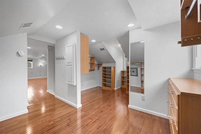 bonus room featuring wood-type flooring and vaulted ceiling