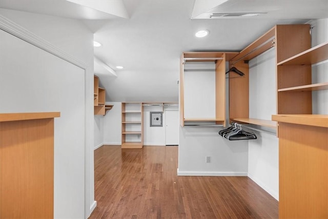 spacious closet featuring wood-type flooring and lofted ceiling