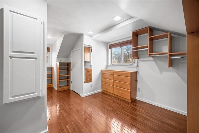 walk in closet featuring hardwood / wood-style flooring and lofted ceiling