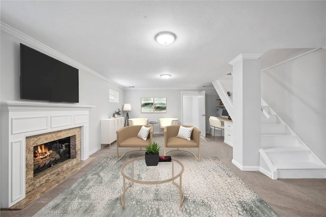 living room featuring carpet, crown molding, and a high end fireplace