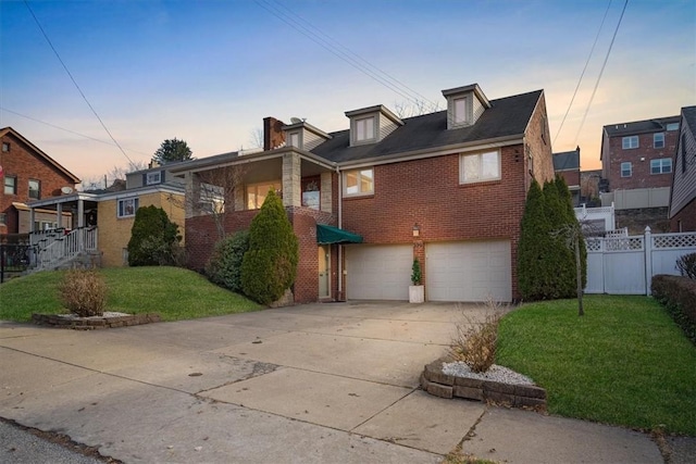 view of front of house featuring a garage and a yard